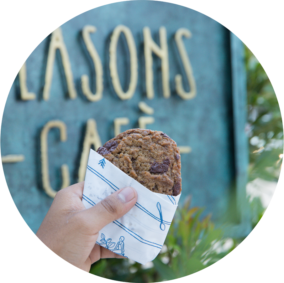 Chocolate Chip Cookie in front of the Seasons Cafe signage.